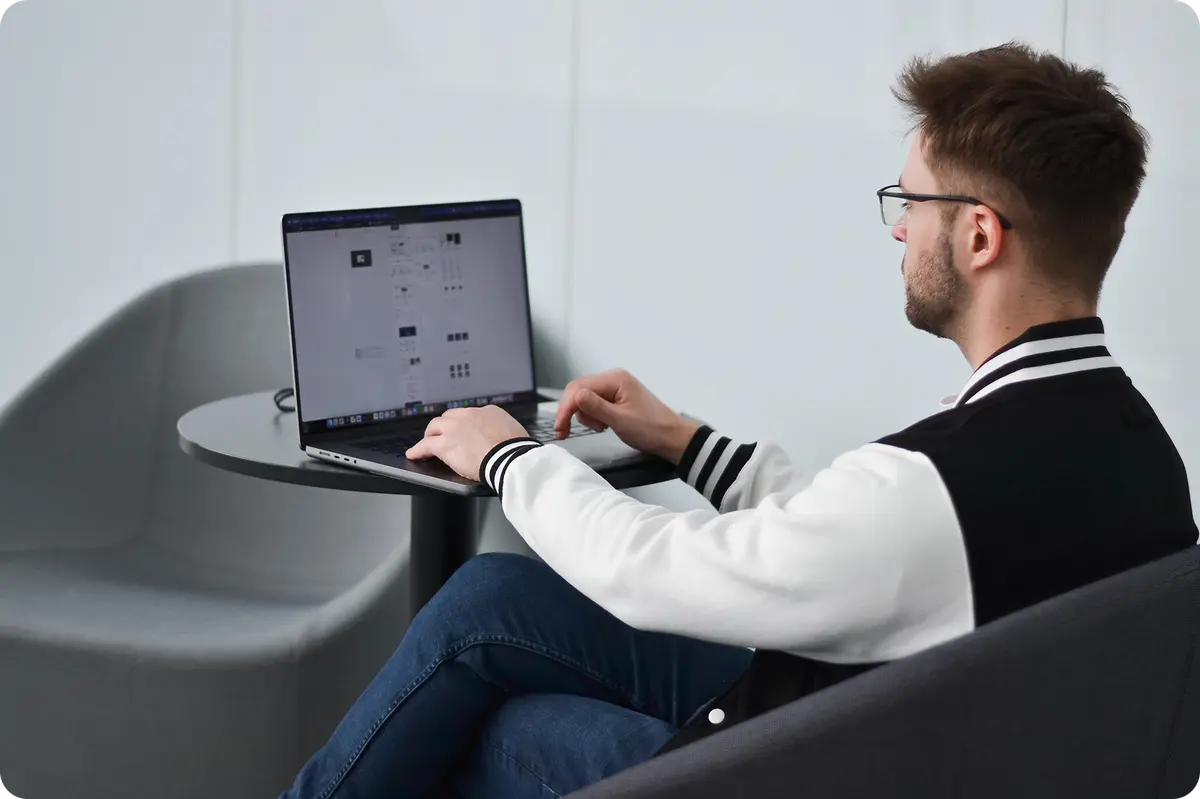 Artūras working at a laptop